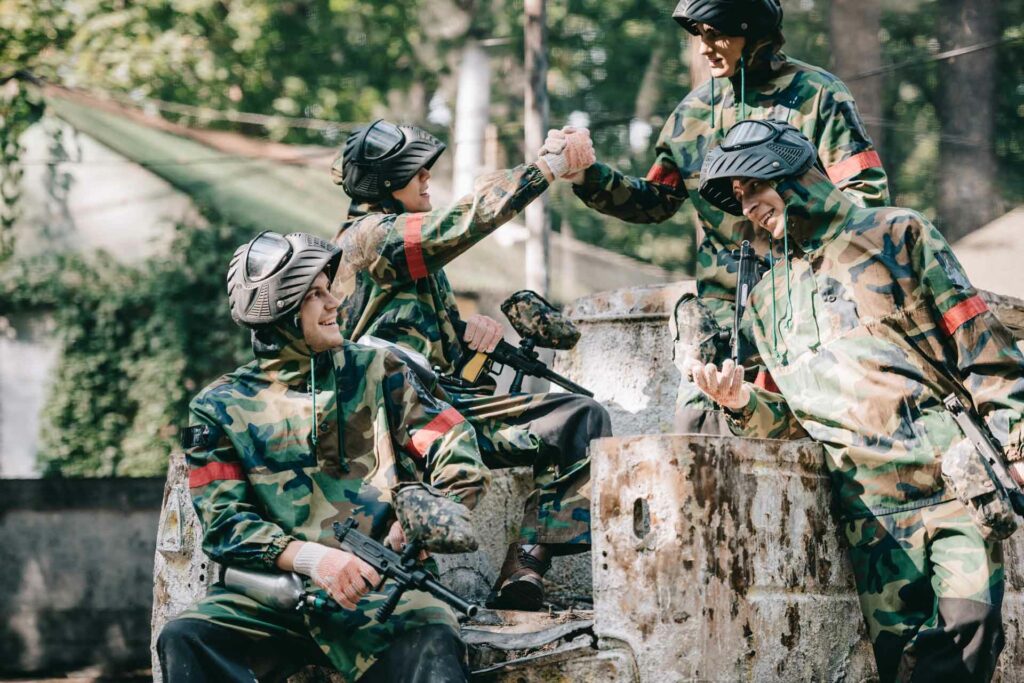 happy paintball team in camouflage celebrating vic 35QR6VF